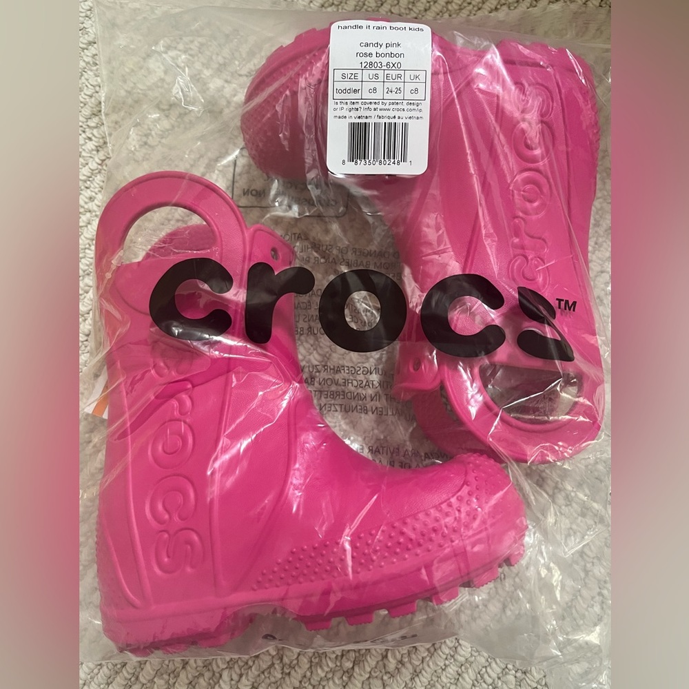 Brand new hot pink crocs rain boots.